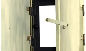 Brass doors of a fireplace insert, one open, showing a black interior with a white opening.