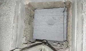 Insidan av en ventilationskanal med blåbetong, redo för radonsanering.