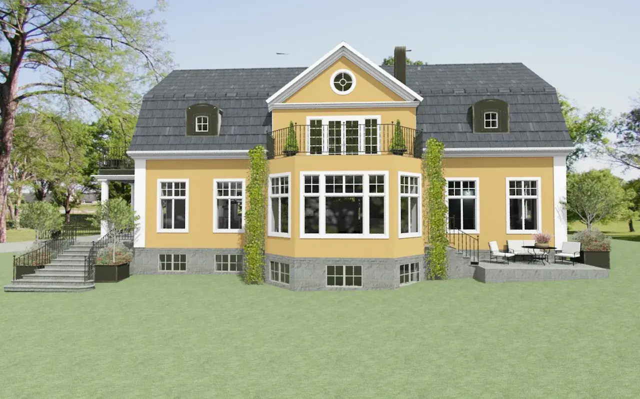 Ett charmigt gult hus med ett mörkt, svart tak. En balkong med smidesräcke och klätterväxter ramar in husets mitt.
